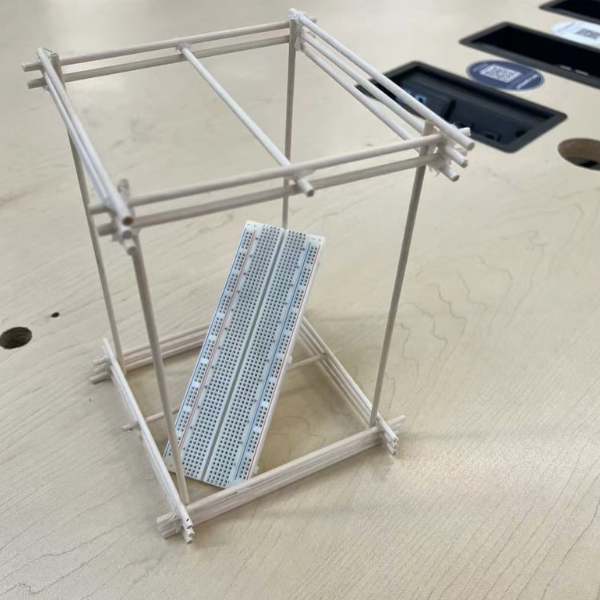Basic prototype frame built with wooden sticks to test size, stability, and internal space for components.